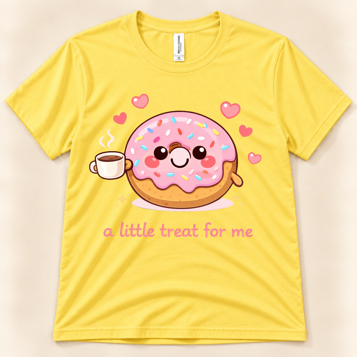 Yellow Bella Canvas 3001 graphic tee featuring a cute pink frosted donut with colorful sprinkles holding a steaming coffee cup and A Little Treat For Me text from New Chapter Tees, a California small business.