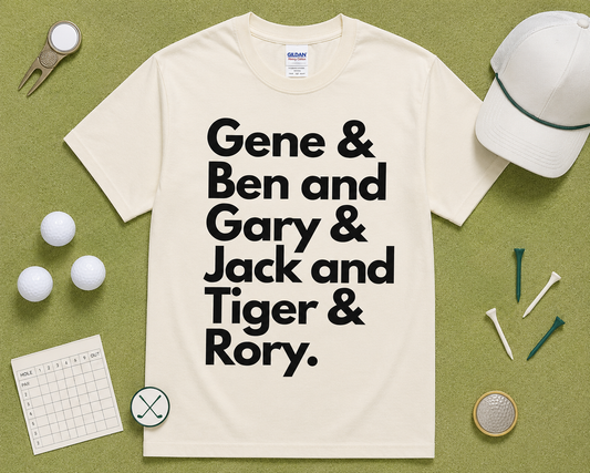 Natural Gildan 5000 golf graphic tee flatlay with Gene Ben Gary Jack Tiger Rory design styled with golf themed accessories on light green grass, funny golf shirt gift, unisex golf apparel made for USA golfers.