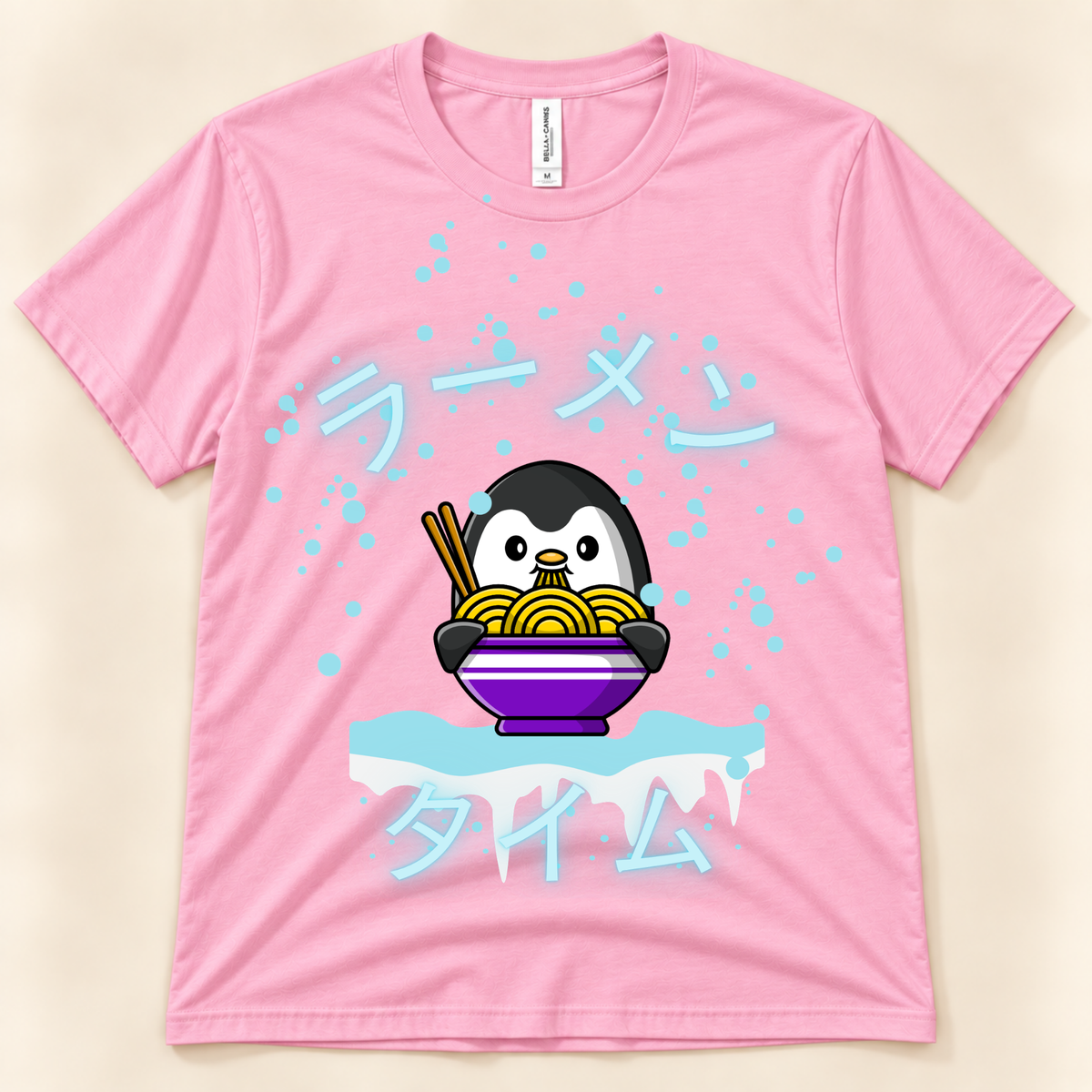 Pink Bella Canvas 3001 kawaii penguin ramen shirt featuring a cute penguin eating noodles with Japanese Ramen Time artwork.