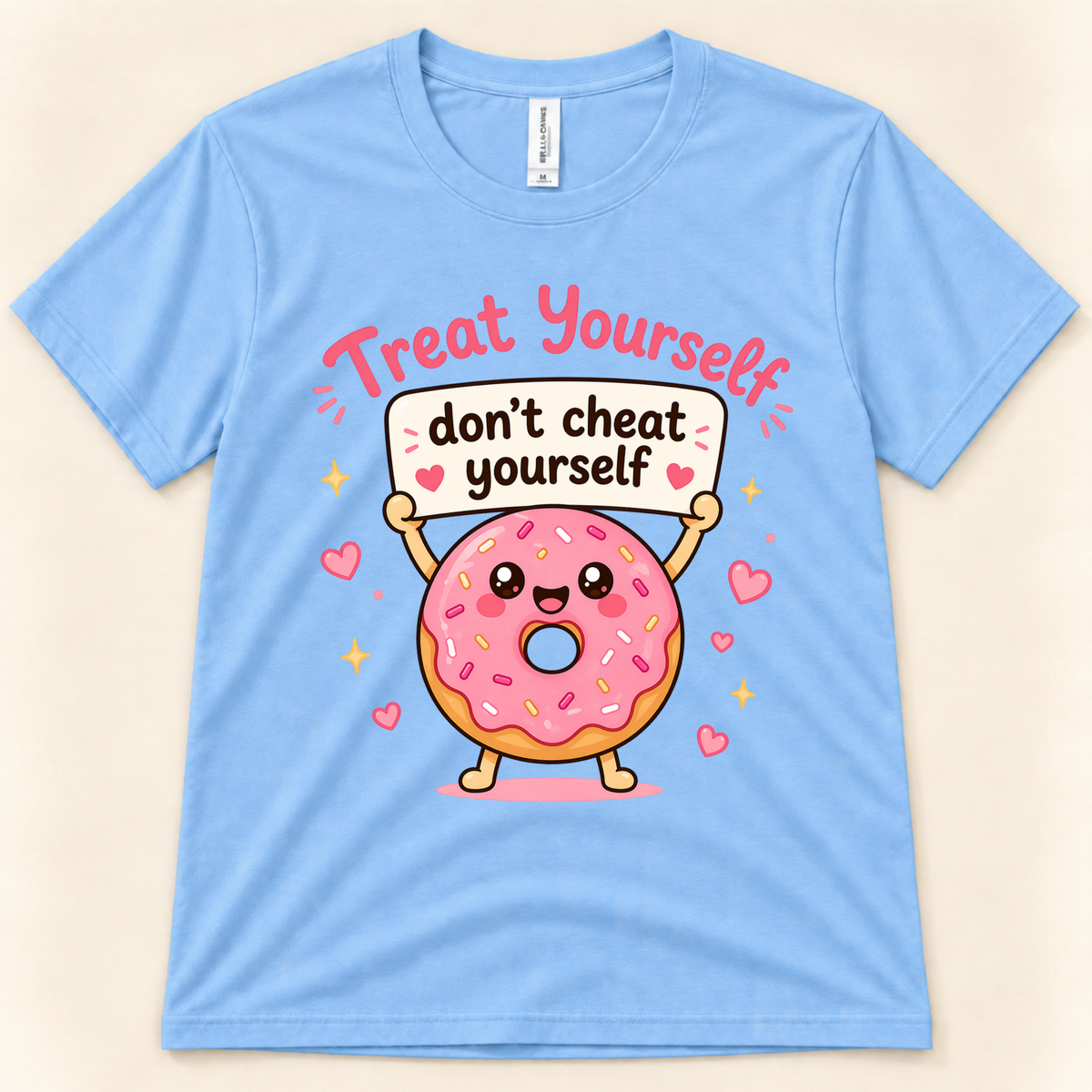 Carolina Blue Bella Canvas 3001 kawaii donut graphic shirt featuring a happy pink sprinkled donut holding a Treat Yourself Don’t Cheat Yourself sign, from New Chapter Tees, a California small business.