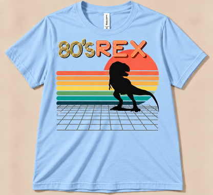 Baby Blue Bella Canvas 3001 80’s REX Tee featuring black T-Rex, colorful 80s sunset and retro dinosaur graphic