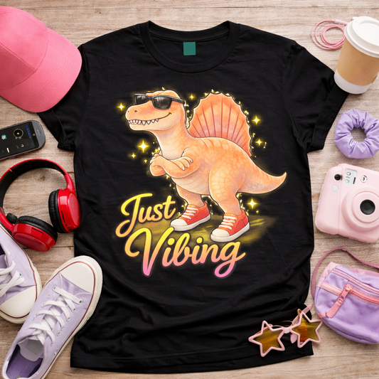 Just Vibing spinosaurus graphic tee on black shirt with sunglasses sneakers and glowing stars aesthetic dinosaur design