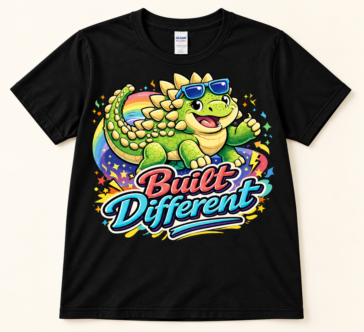 Black Gildan 5000 Built Different Ankylosaurus Tee with green dinosaur, blue sunglasses and colorful rainbow graphic