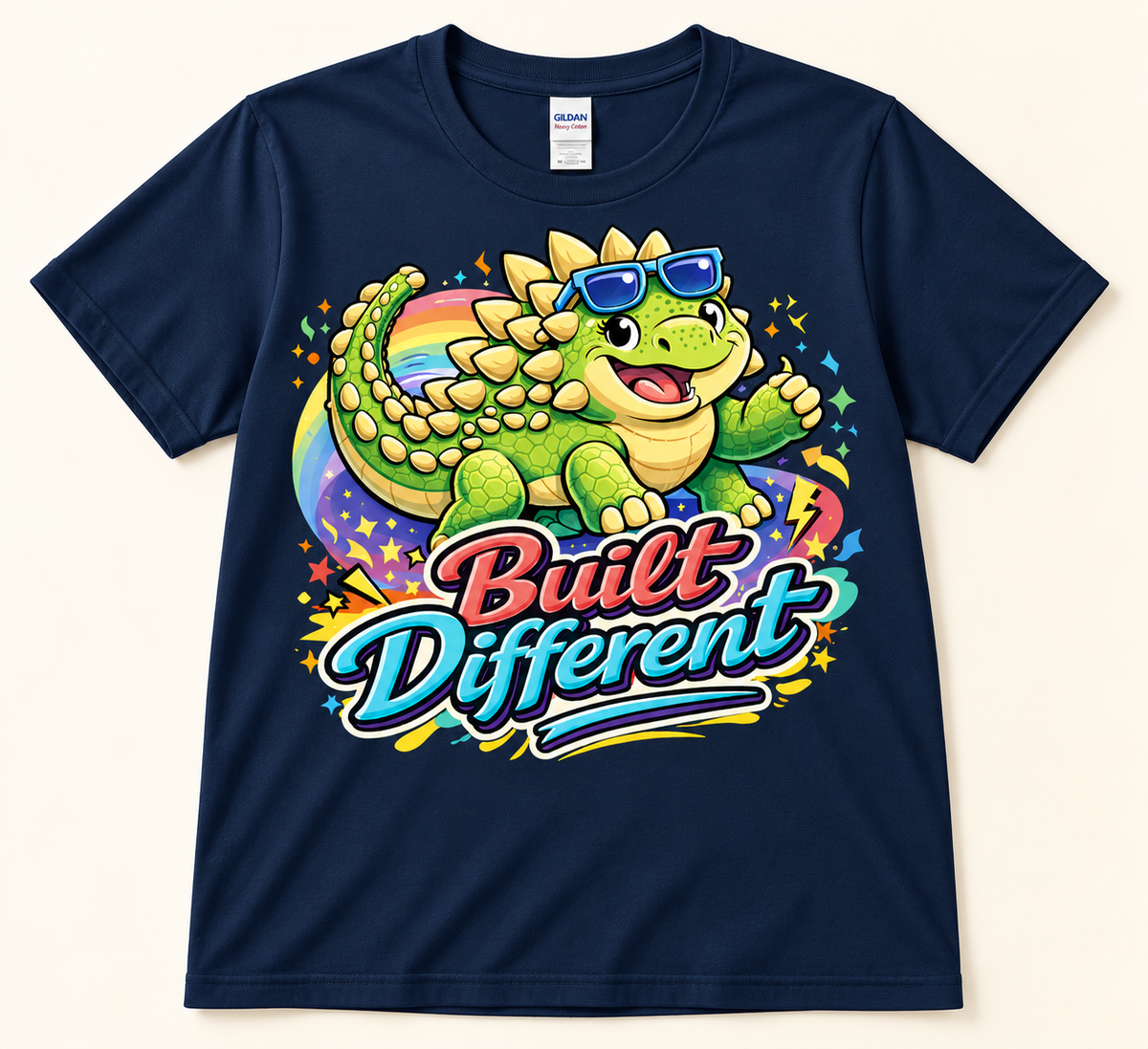 Navy Gildan 5000 Built Different Ankylosaurus graphic tee featuring a green dinosaur in blue sunglasses with rainbow art