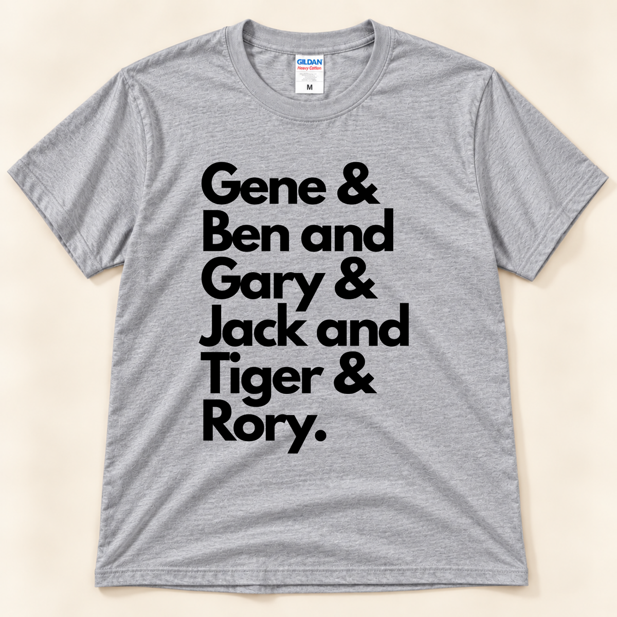 Sport Gray Gildan 5000 golf graphic tee featuring black typography honoring career Grand Slam winners Gene Sarazen, Ben Hogan, Gary Player, Jack Nicklaus, Tiger Woods and Rory McIlroy, from New Chapter Tees, a California small business.