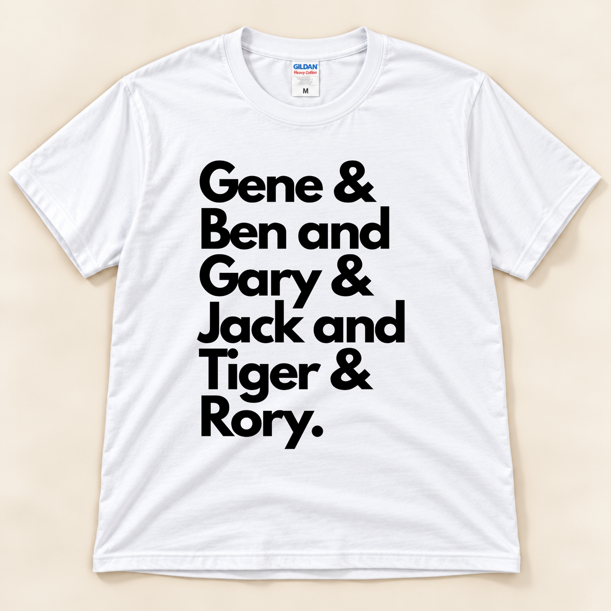 White Gildan 5000 Career Grand Slam golf shirt featuring bold black typography with the names Gene, Ben, Gary, Jack, Tiger and Rory, celebrating legendary golfers from New Chapter Tees, a California small business.