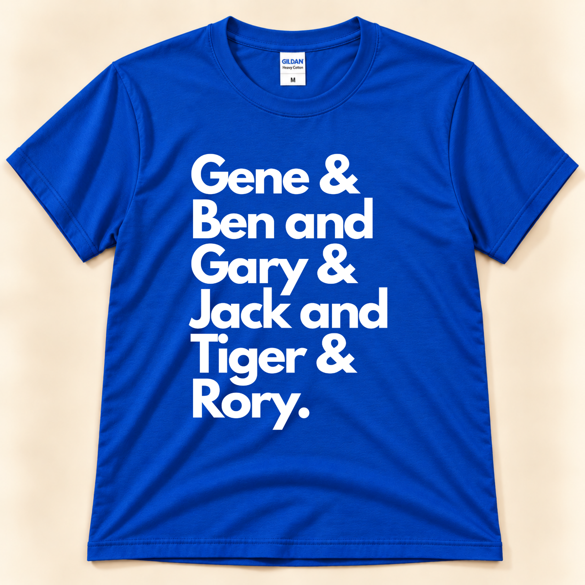 Royal Blue Gildan 5000 Career Grand Slam golf tee with bold white stacked typography listing Gene, Ben, Gary, Jack, Tiger and Rory, a golf history-inspired design from New Chapter Tees, a California small business.