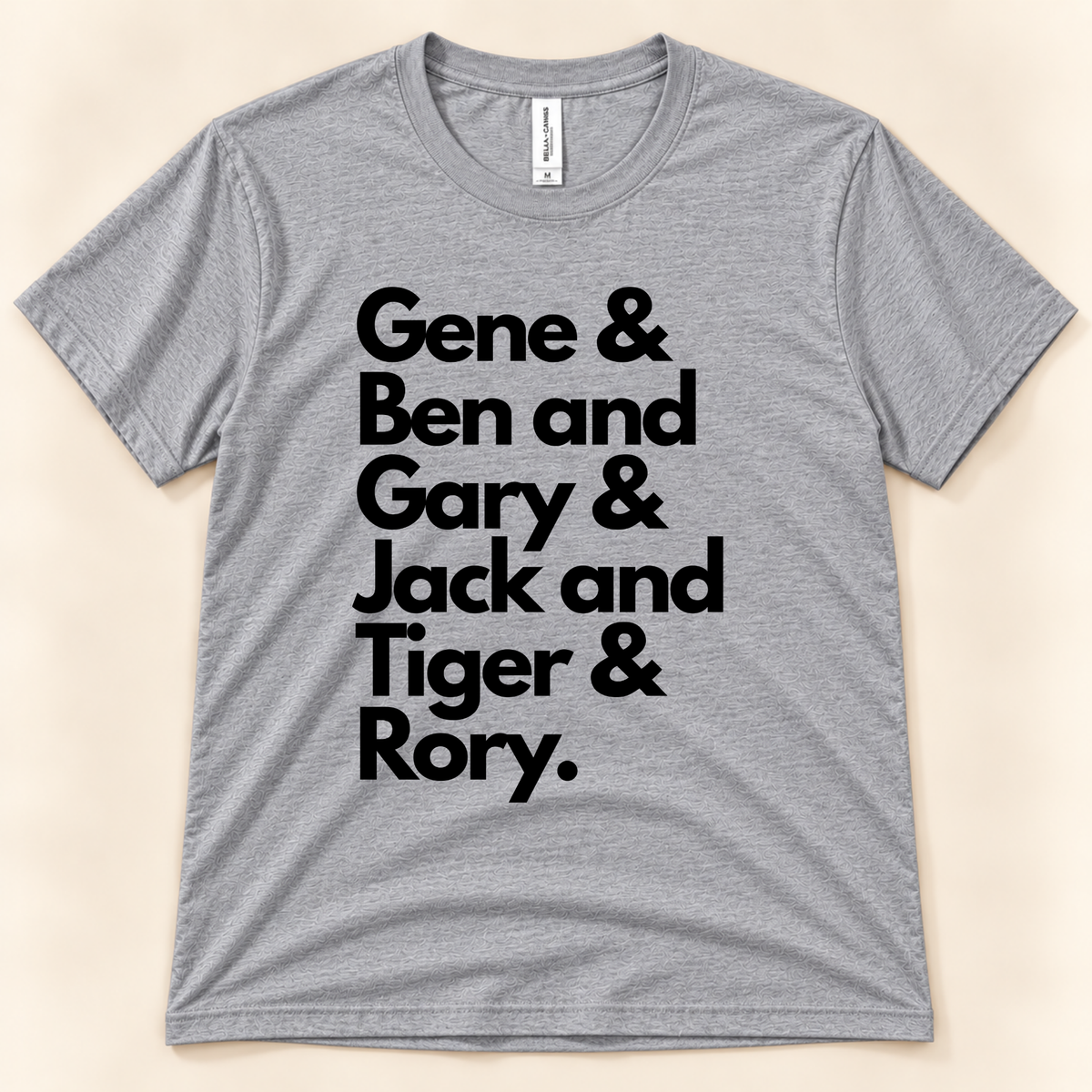 Athletic Heather Bella Canvas 3001 Career Grand Slam golf graphic tee with bold black typography listing Gene Sarazen, Ben Hogan, Gary Player, Jack Nicklaus, Tiger Woods and Rory McIlroy, from New Chapter Tees, a California small business.