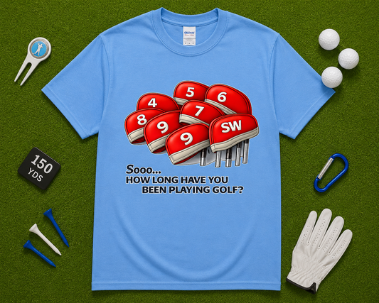 Carolina Blue golf shirt flatlay featuring funny How Long Have You Been Playing Golf graphic with golf headcovers, golf accessories, and putting green styling. Funny golfer gift shirt for men and women, golf tournament apparel, weekend golf outfit, and casual golf lifestyle tee popular across California, Texas, Florida, Arizona, and the United States.
