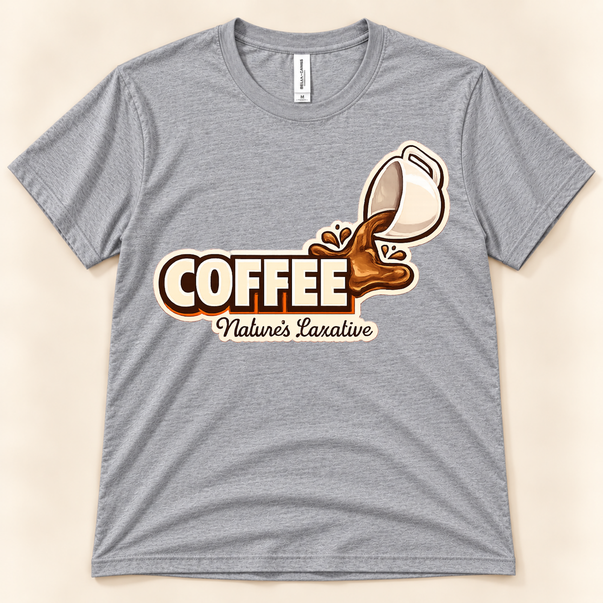 Athletic Heather Bella Canvas 3001 Coffee Nature’s Laxative graphic tee featuring a funny spilled coffee cup design for coffee lovers from New Chapter Tees, a California small business.