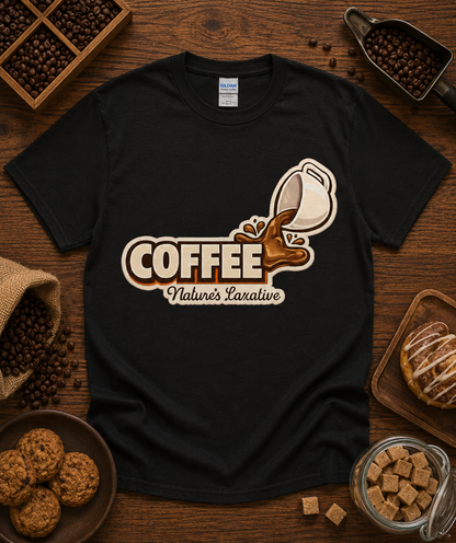 Coffee Natures Laxative funny coffee graphic shirt displayed on a black Gildan 5000 classic heavy cotton unisex tee in a cozy coffee shop flat lay with roasted coffee beans espresso accessories pastries chocolate and rustic cafe props perfect for coffee lovers baristas espresso fans and coffee gift shopping across the United States