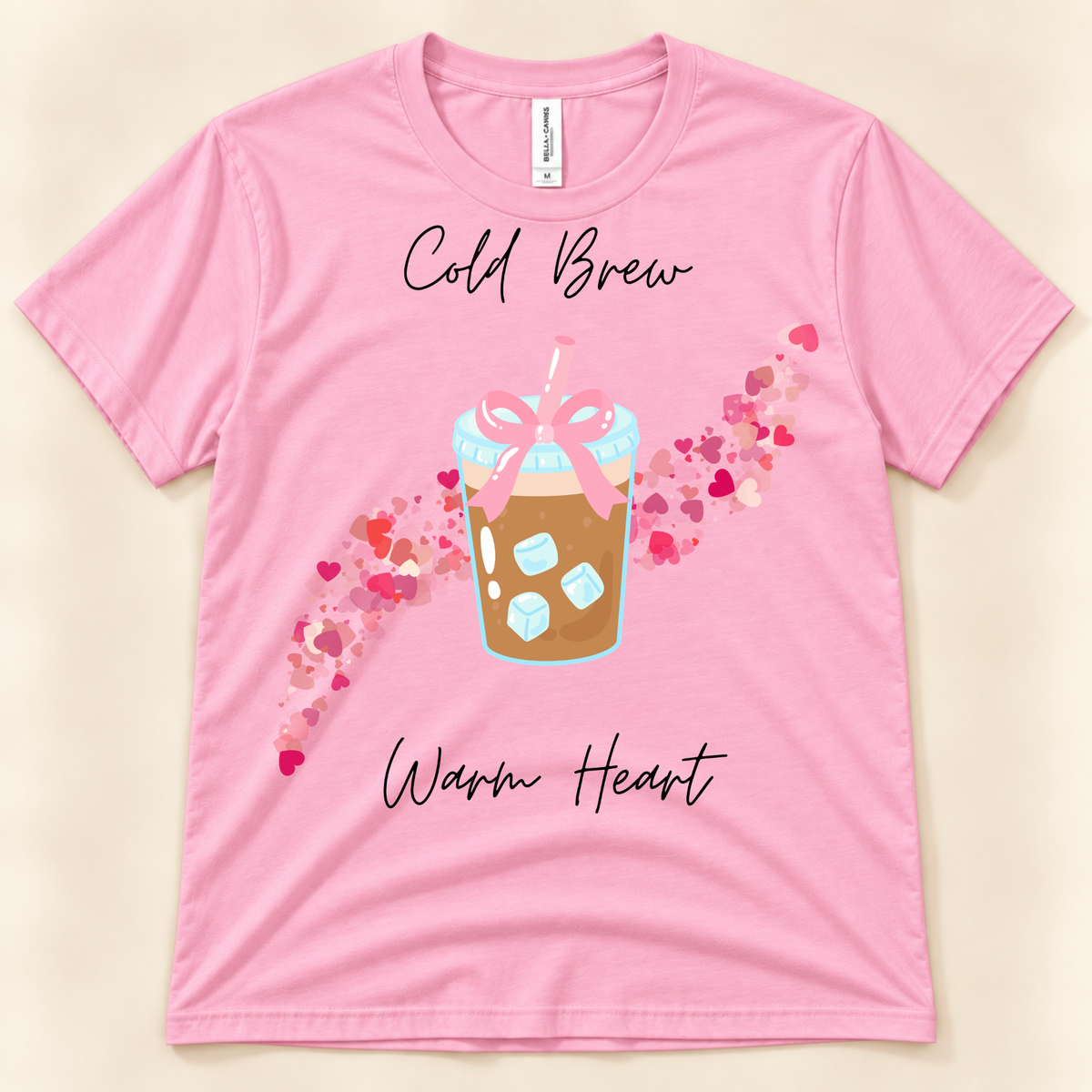 Pink Bella Canvas 3001 cute coffee shirt featuring a cold brew drink with pink bow and colorful heart design.
