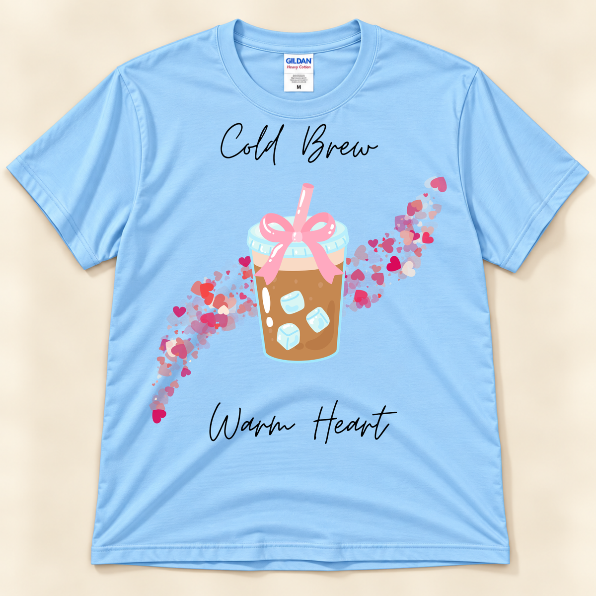 Light Blue Gildan 5000 cold brew graphic tee featuring an iced coffee cup, pink bow and colorful heart trail.