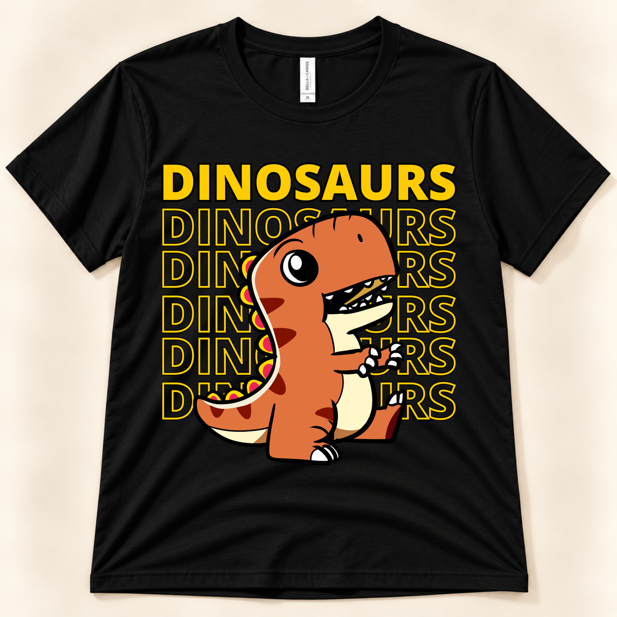 Black Bella Canvas 3001 dinosaur graphic tee featuring a cute orange T Rex with bold repeated Dinosaurs lettering for dinosaur lovers.