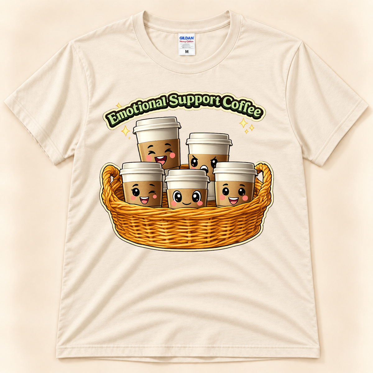 Natural Gildan 5000 Emotional Support Coffee graphic tee featuring cute kawaii coffee cups with playful faces in a woven basket from New Chapter Tees, a California small business.