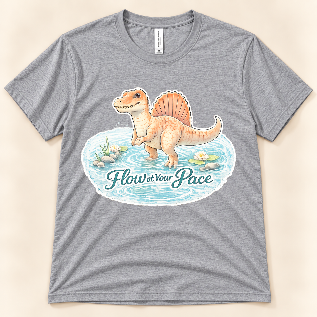Flow at Your Pace Spinosaurus graphic tee in Athletic Heather featuring a cute dinosaur in a peaceful pond from New Chapter Tees, a California small business.