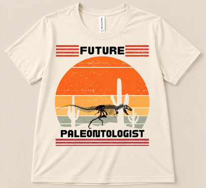 Natural Bella Canvas 3001 Future Paleontologist Tee with dinosaur fossil skeleton, retro sunset and desert cactus design