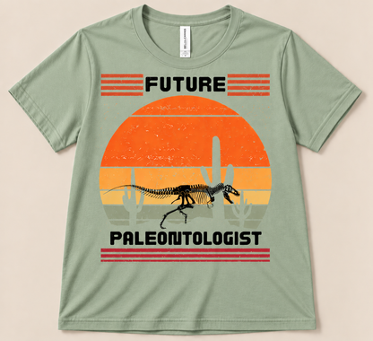 Sage Bella Canvas 3001 Future Paleontologist dinosaur shirt featuring a fossil skeleton and vintage desert sunset