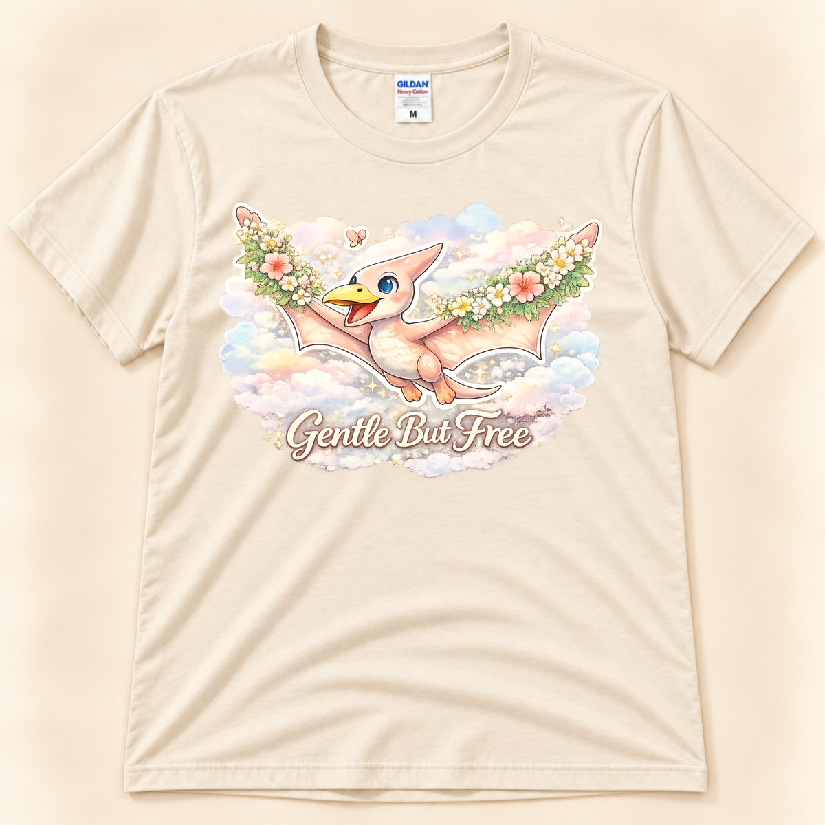 Gentle But Free cute pterodactyl graphic tee in Natural with floral dinosaur artwork and dreamy pastel clouds from New Chapter Tees, a California small business.
