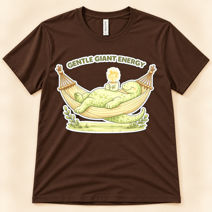 Brown Bella Canvas 3001 dinosaur shirt featuring the Gentle Giant Energy brontosaurus relaxing in a hammock with a warm drink.