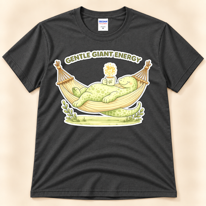 Charcoal Gildan 5000 Gentle Giant Energy dinosaur tee with a cute green brontosaurus relaxing in a hammock and holding a warm drink.