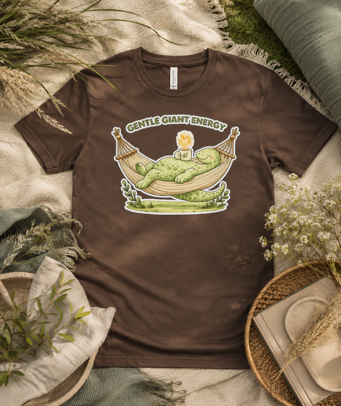 Gentle Giant Energy Bella Canvas Premium Soft Tee in Brown featuring relaxing dinosaur hammock artwork for cozy everyday outfits in the USA.