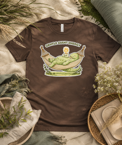 Gentle Giant Energy Bella Canvas Premium Soft Tee in Brown featuring relaxing dinosaur hammock artwork for cozy everyday outfits in the USA.