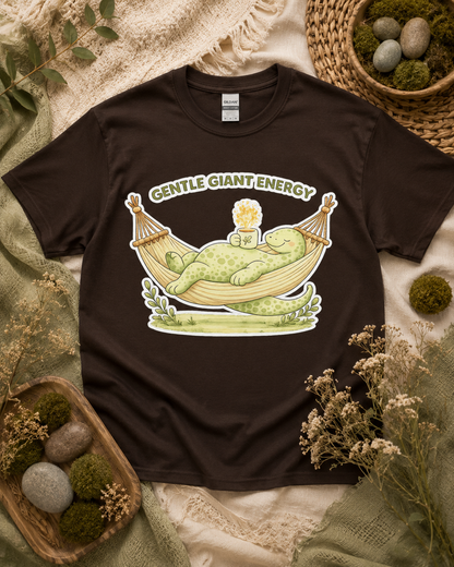 Gentle Giant Energy dinosaur shirt on Dark Chocolate Gildan Heavy Cotton featuring a cozy dinosaur hammock design for relaxing everyday casual wear in the USA.