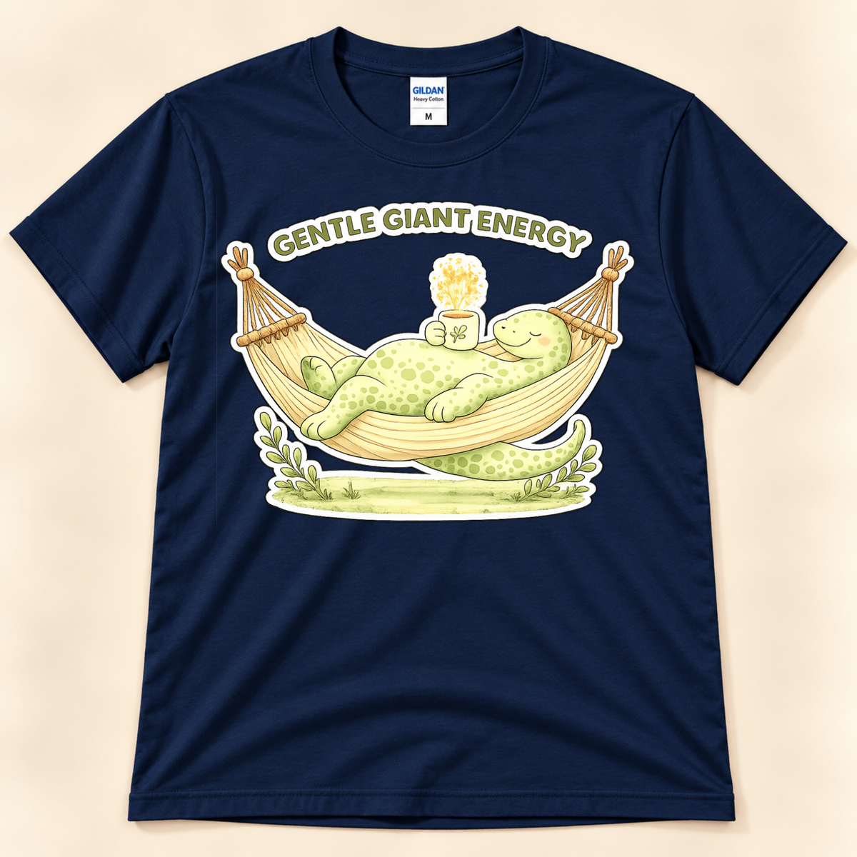 Navy Gildan 5000 Gentle Giant Energy graphic tee featuring a cute green brontosaurus relaxing in a hammock with a cozy warm drink.