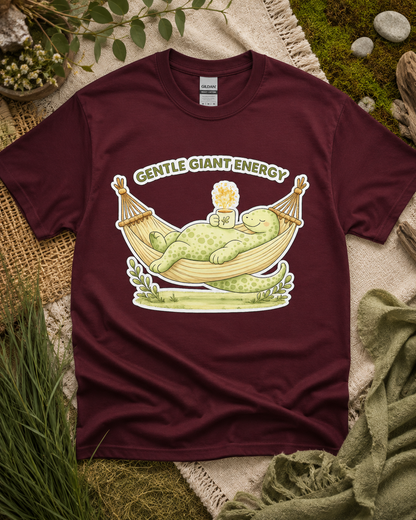 Gentle Giant Energy dinosaur shirt on Maroon Gildan Heavy Cotton with relaxing dinosaur hammock artwork for cozy lifestyle outfits and thoughtful gifts in the USA.