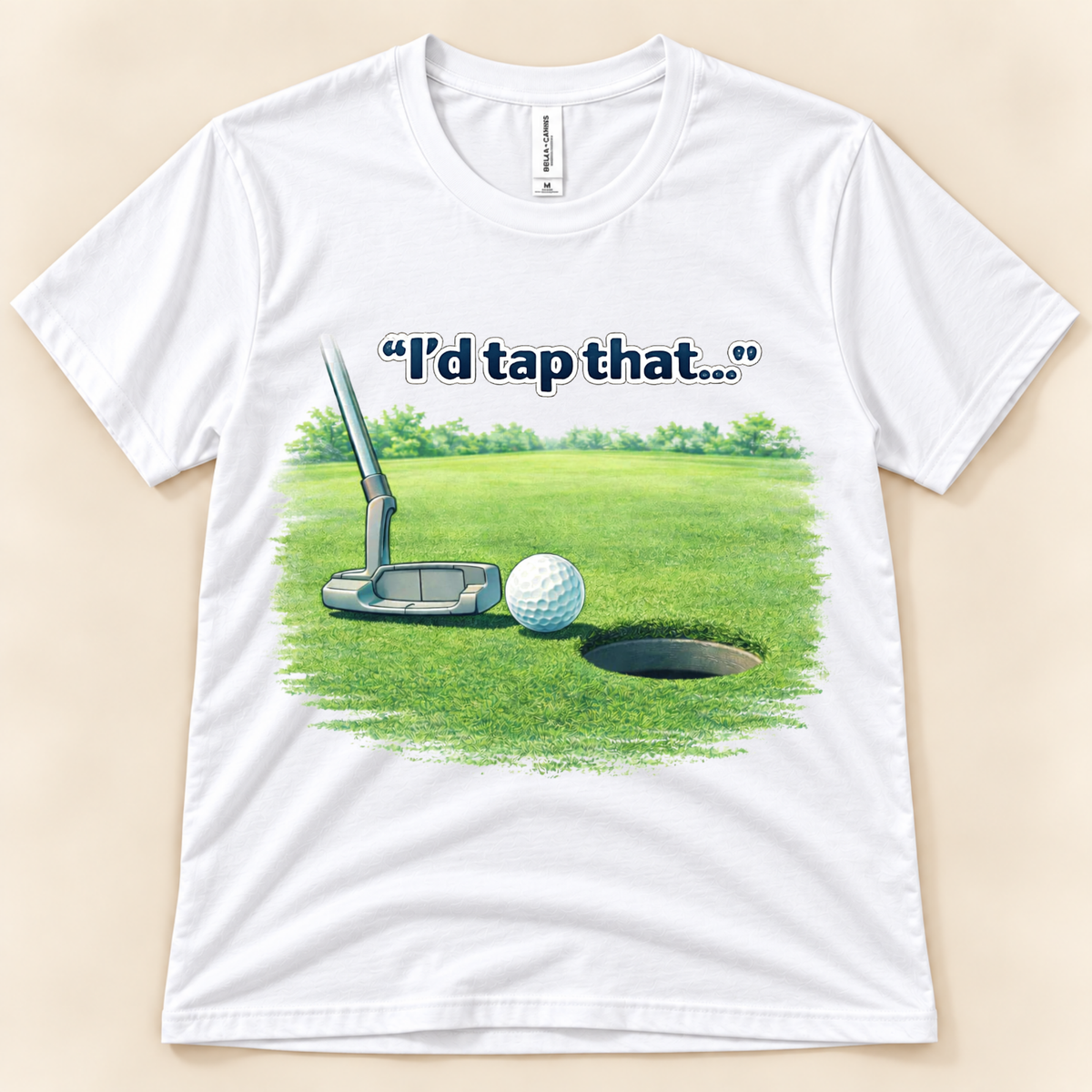 White Bella Canvas 3001 I’d Tap That funny golfer tee featuring a golf ball near the hole with a putter on the green from New Chapter Tees, a California small business.