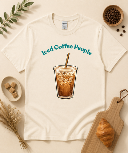 Natural iced coffee graphic tee featuring minimal cold brew cup design with cozy neutral coffee aesthetic props