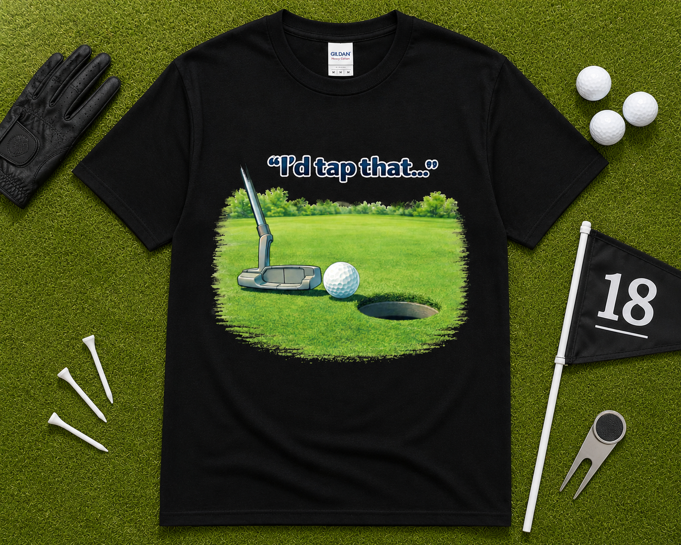 Black golf graphic tee flatlay featuring I'd Tap That putting design on Gildan shirt with golf accessories, funny golfer gift shirt for men and women in the USA.