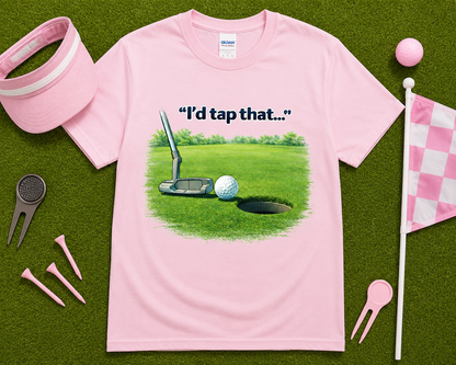 Light pink golf graphic t shirt flatlay with I'd Tap That putting design and golf accessories, fun golf gift shirt for women golfers and golf enthusiasts.