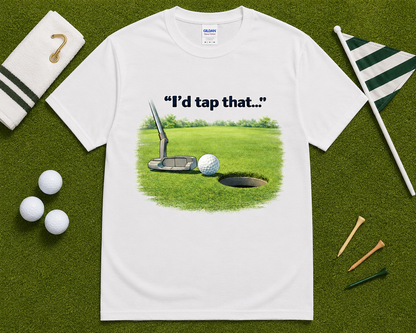 White golf graphic t shirt flatlay with I'd Tap That putting design and golf accessories, funny golf lover gift shirt for casual and competitive golfers.