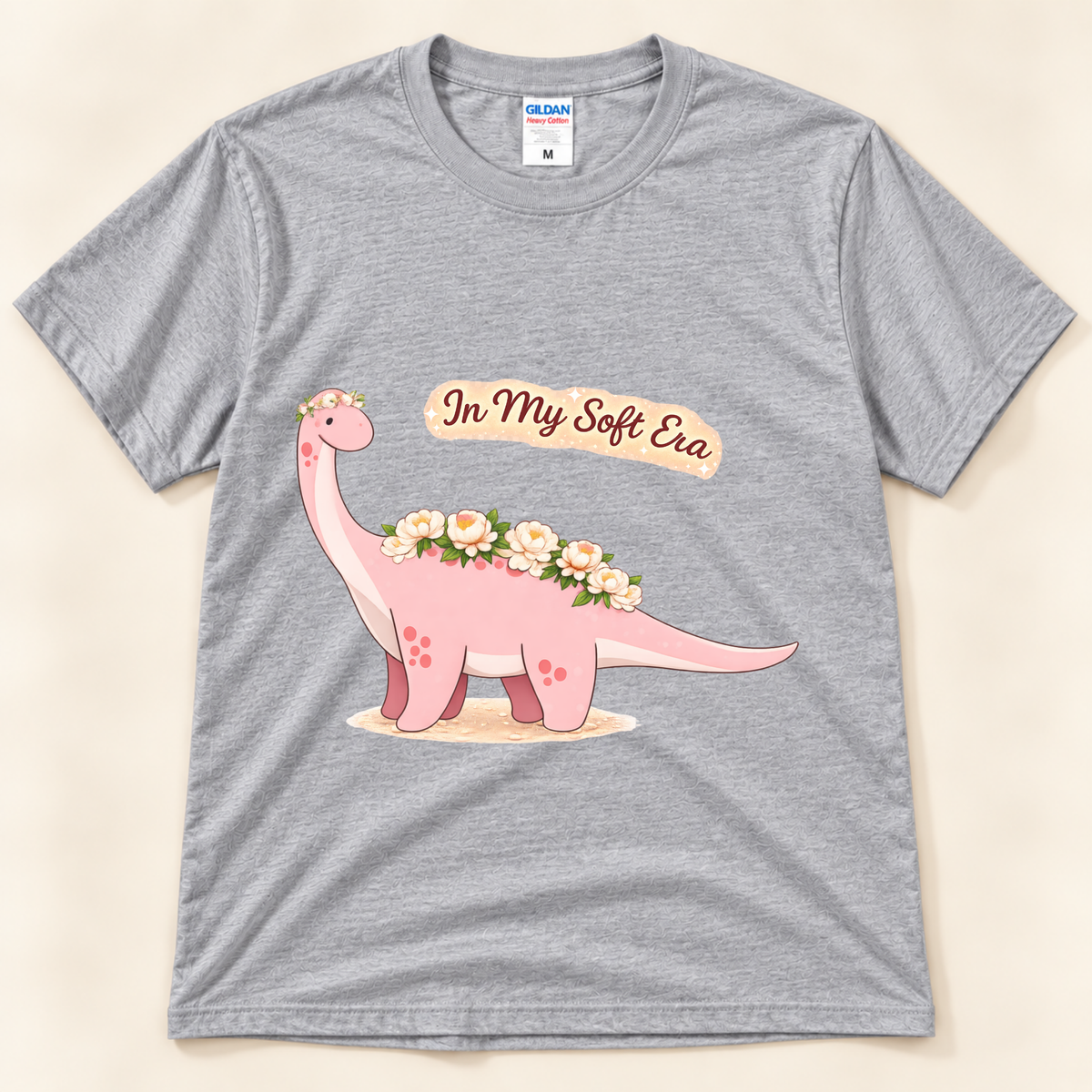 Sport Gray Gildan 5000 In My Soft Era graphic tee featuring a cute pink Brontosaurus decorated with flowers from New Chapter Tees, a California small business.