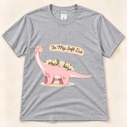 Sport Gray Gildan 5000 In My Soft Era graphic tee featuring a cute pink Brontosaurus decorated with flowers from New Chapter Tees, a California small business.