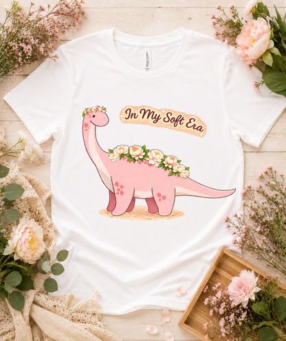 Premium Bella Canvas 3001 white soft dinosaur graphic shirt featuring pink floral dinosaur In My Soft Era design cute aesthetic gift for women girls USA