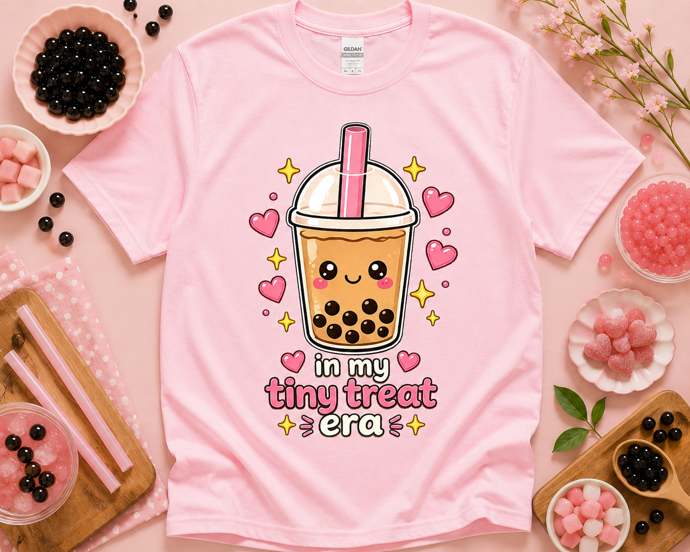 Light pink Gildan 5000 In My Tiny Treat Era shirt with kawaii boba tea graphic and sweet themed flatlay