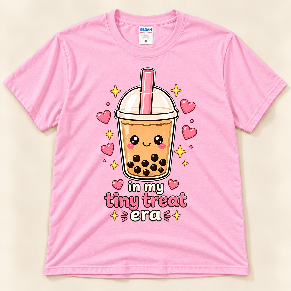 Light Pink Gildan 5000 bubble tea lover shirt featuring a cute smiling boba cup with tapioca pearls, pink hearts, golden sparkles, and In My Tiny Treat Era saying from New Chapter Tees, a California small business.