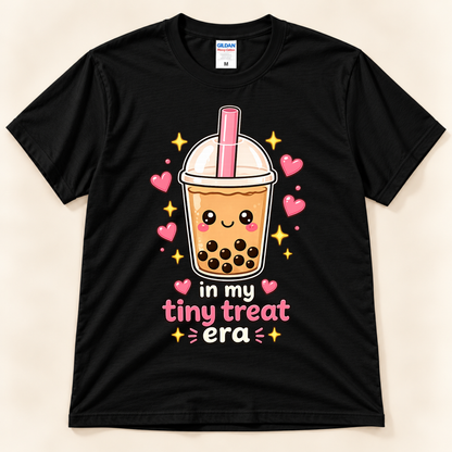 Black Gildan 5000 bubble tea graphic tee featuring a cute smiling boba milk tea cup with pink straw, black tapioca pearls, hearts, and In My Tiny Treat Era saying from New Chapter Tees, a California small business.