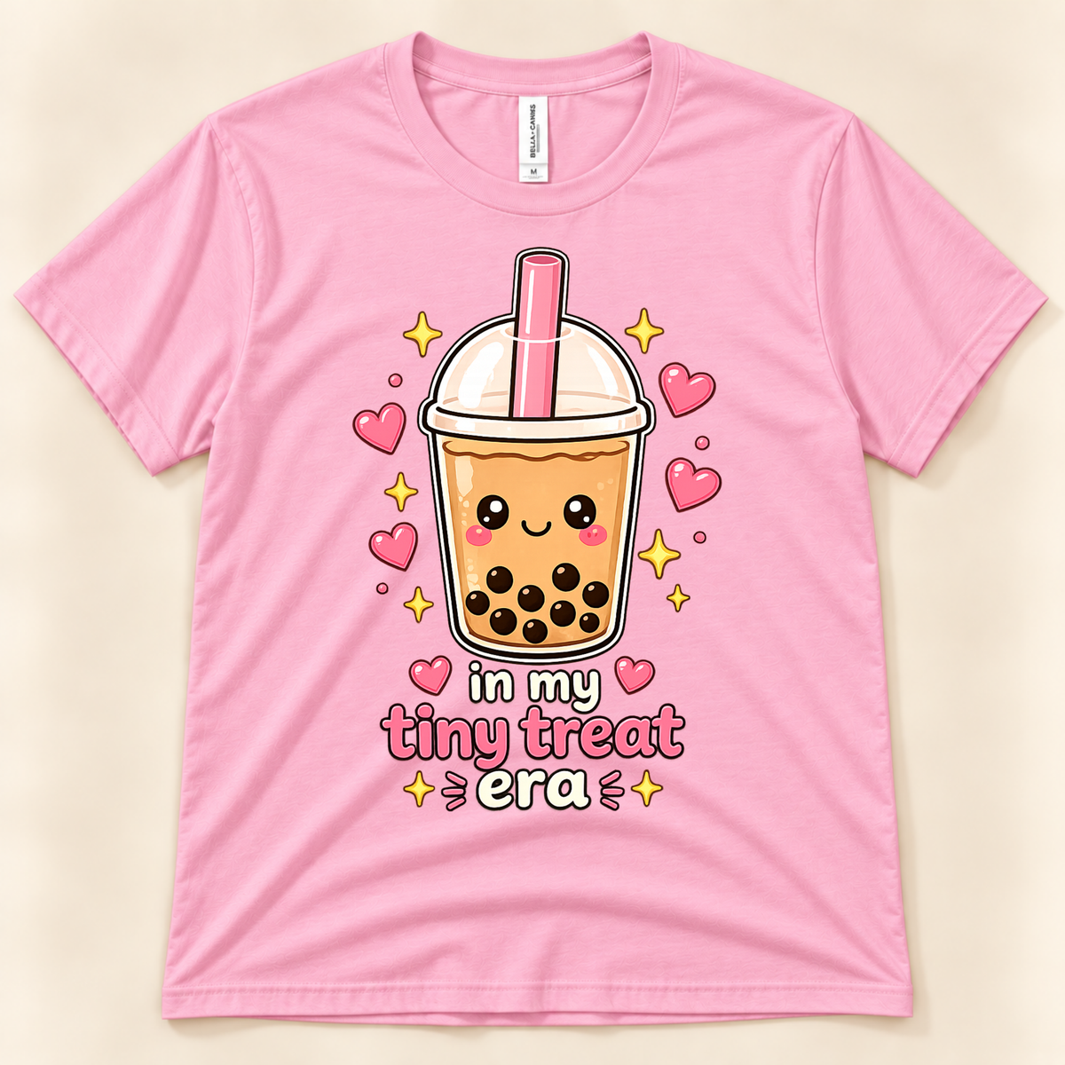 Pink Bella Canvas 3001 cute boba tea shirt featuring a smiling milk tea cup with black tapioca pearls, pink straw, hearts, and In My Tiny Treat Era lettering from New Chapter Tees, a California small business.