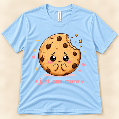 Baby Blue Bella Canvas 3001 Just One More Cookie graphic tee featuring an adorable kawaii chocolate chip cookie with hearts, sparkles and a funny cookie lover saying from New Chapter Tees, a California small business.