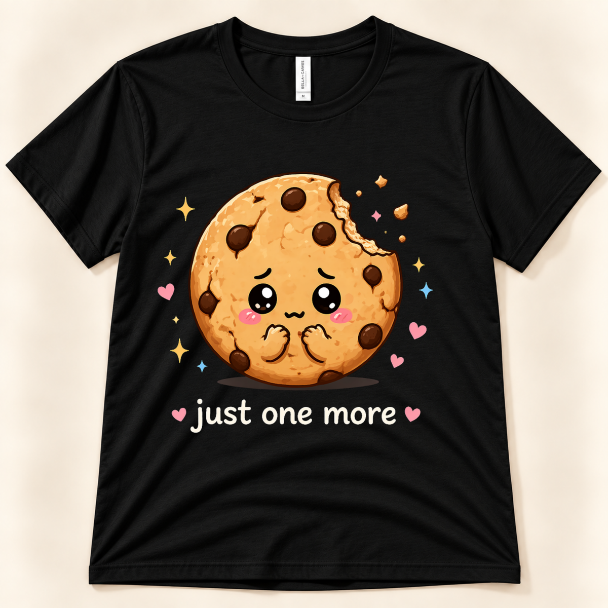 Black Bella Canvas 3001 Just One More Cookie tee featuring a cute bitten chocolate chip cookie, colorful hearts, sparkles and playful food humor from New Chapter Tees, a California small business.