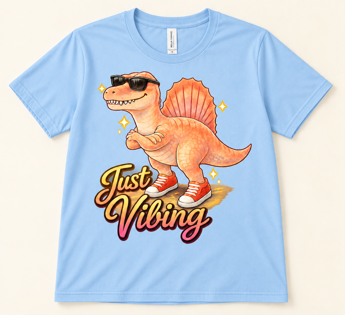 Baby Blue Bella Canvas 3001 Just Vibing dinosaur shirt with colorful Spinosaurus, sunglasses and retro graphic