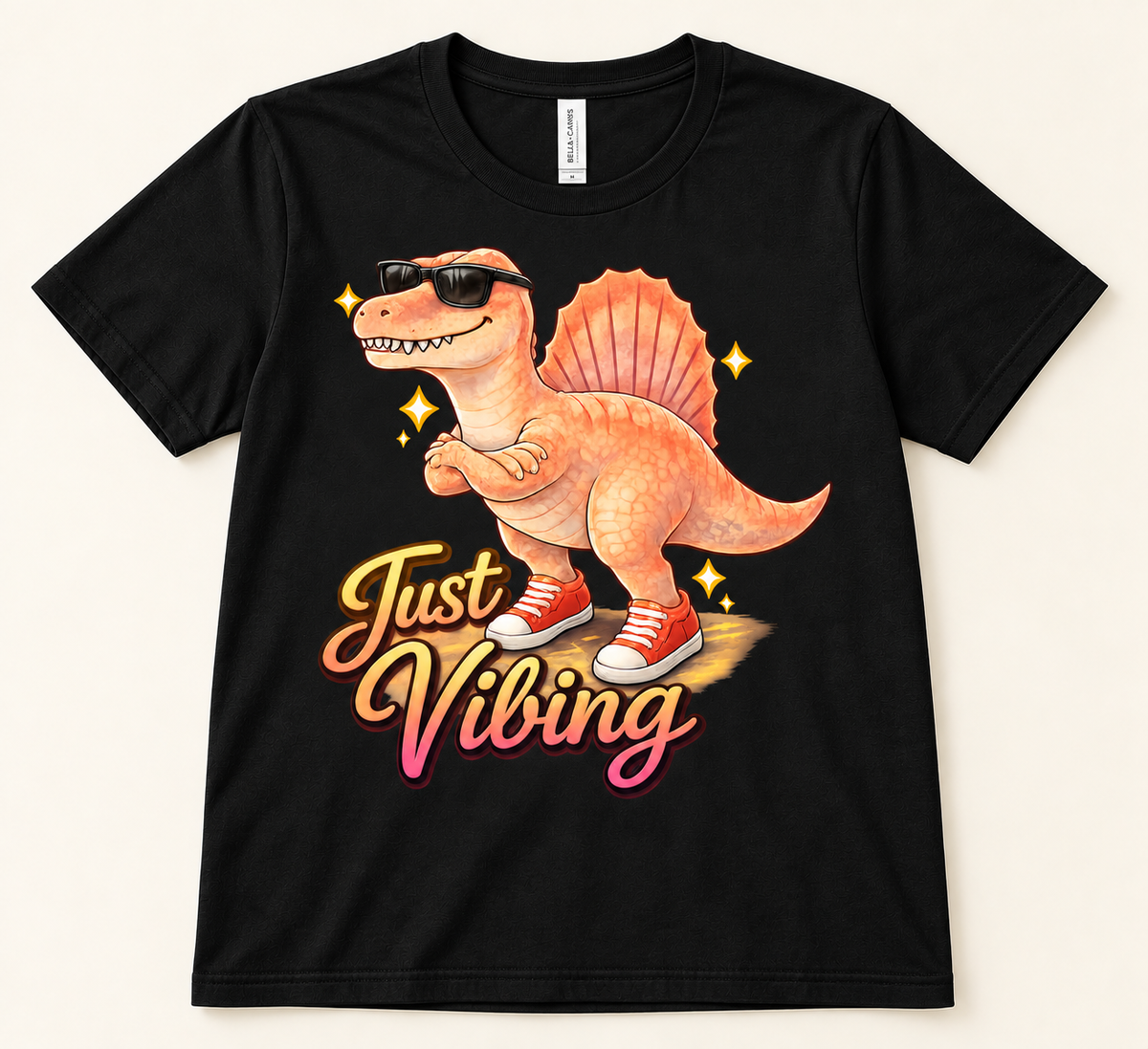 Black Bella Canvas 3001 Just Vibing Spinosaurus Tee with orange dinosaur, sunglasses, red sneakers and retro lettering