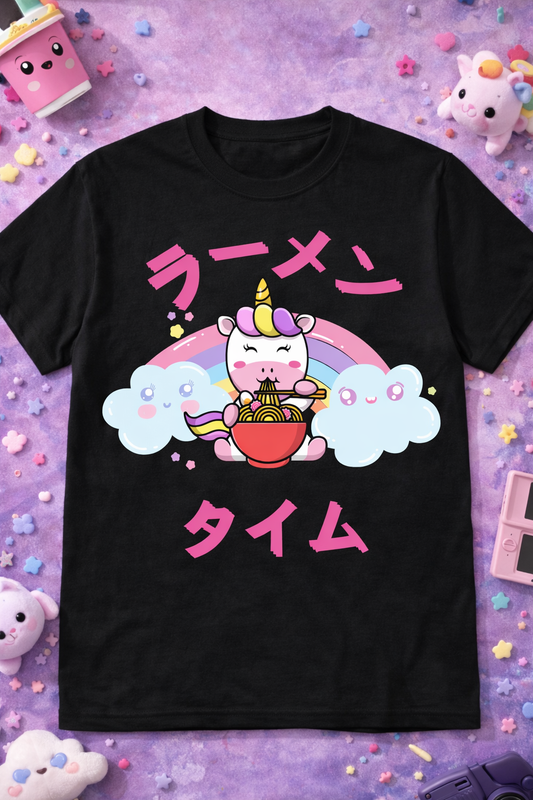 Black kawaii unicorn ramen graphic tee with cute anime design, rainbow and clouds, styled in a pastel aesthetic flatlay with colorful foodie props.