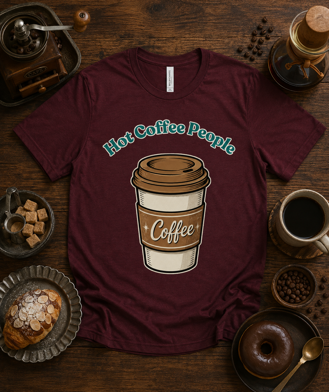 Hot Coffee People premium coffee lover graphic tee on maroon Bella Canvas 3001 featuring retro coffee cup design for café lovers coffee drinkers baristas and cozy fall fashion throughout the USA