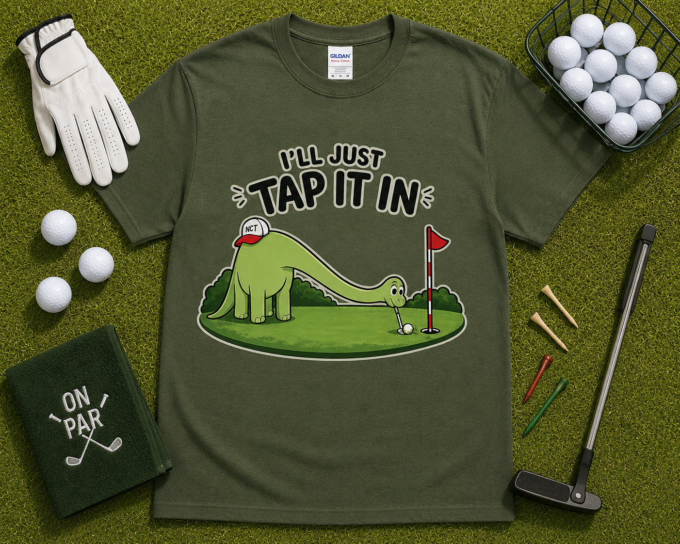 Military Green golf dinosaur shirt flatlay featuring Ill Just Tap It In brontosaurus golfer graphic on grass golf course themed background funny golf apparel gift for golfers USA
