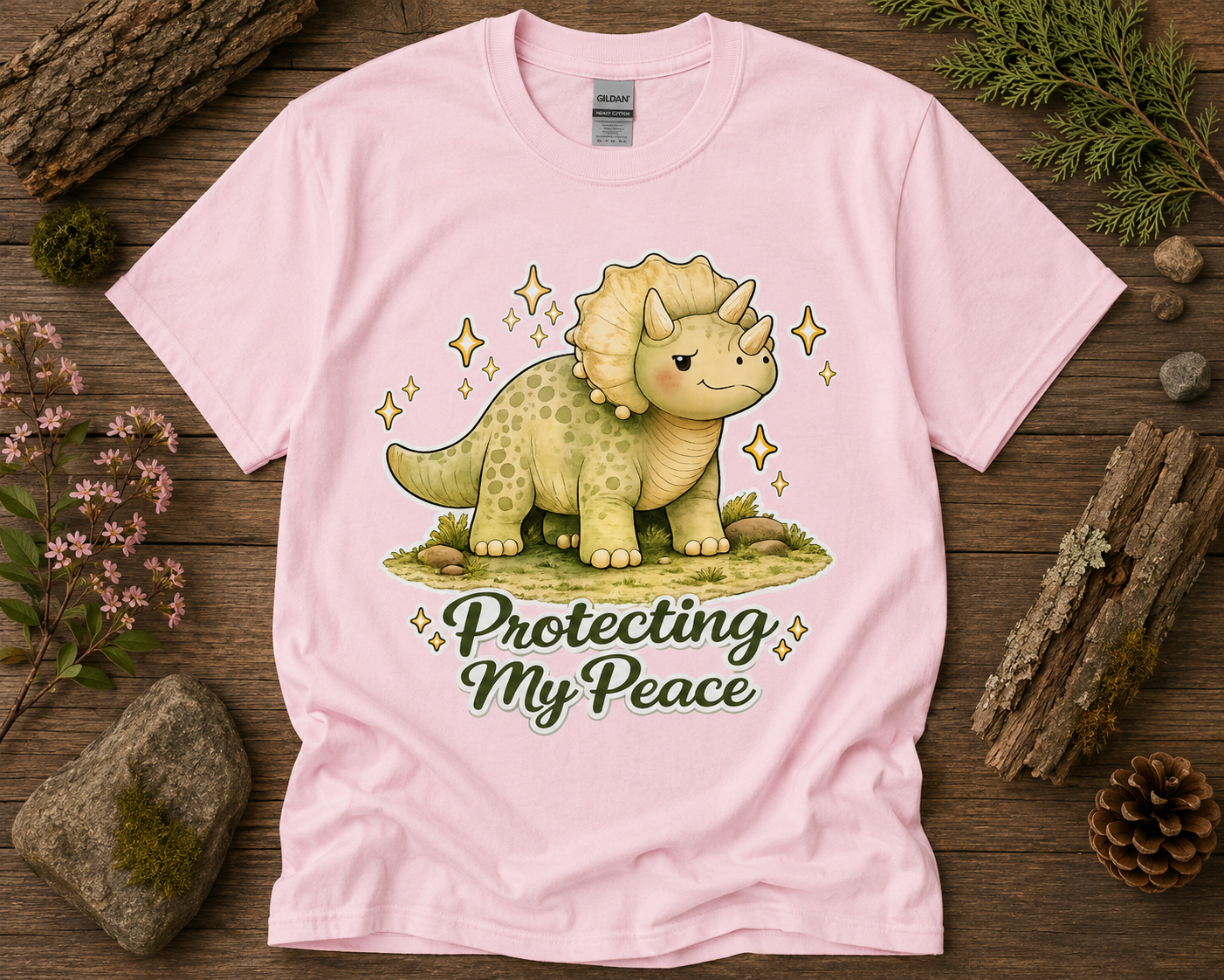 Protecting My Peace triceratops graphic shirt on light pink Gildan 5000 featuring cute dinosaur self care aesthetic